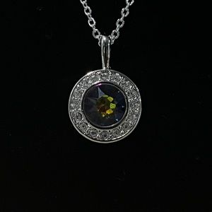 Swarovski crystal multi-colored center stone with white crystal set bezel.